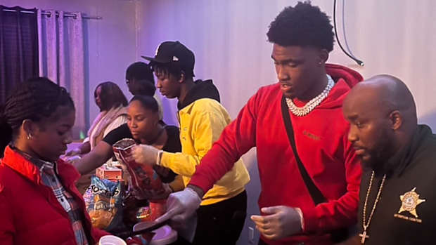 Hogs' signee Charlie Collins serving food at public event